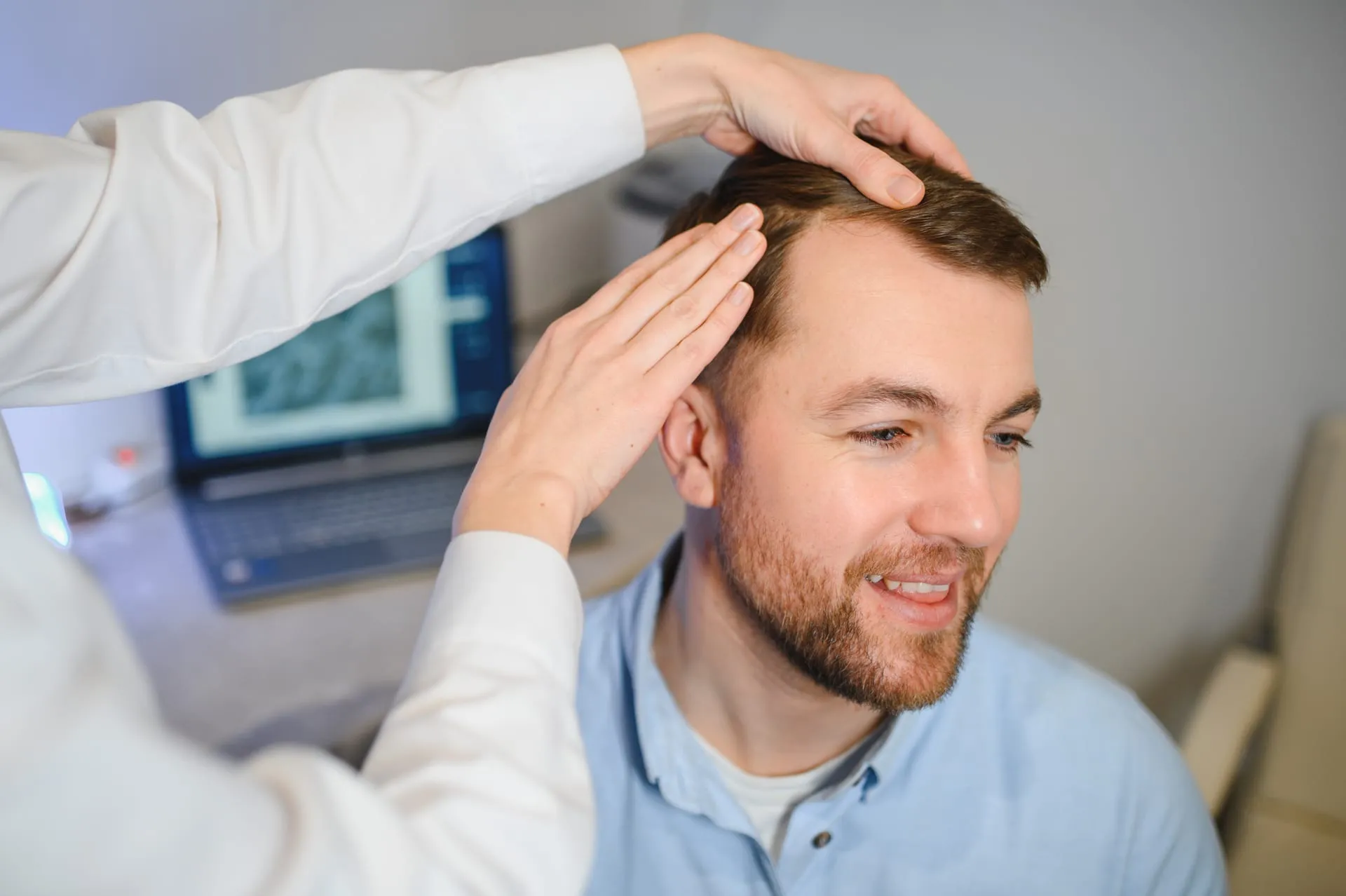 Examination of hair and scalp with a magnified image on the screen