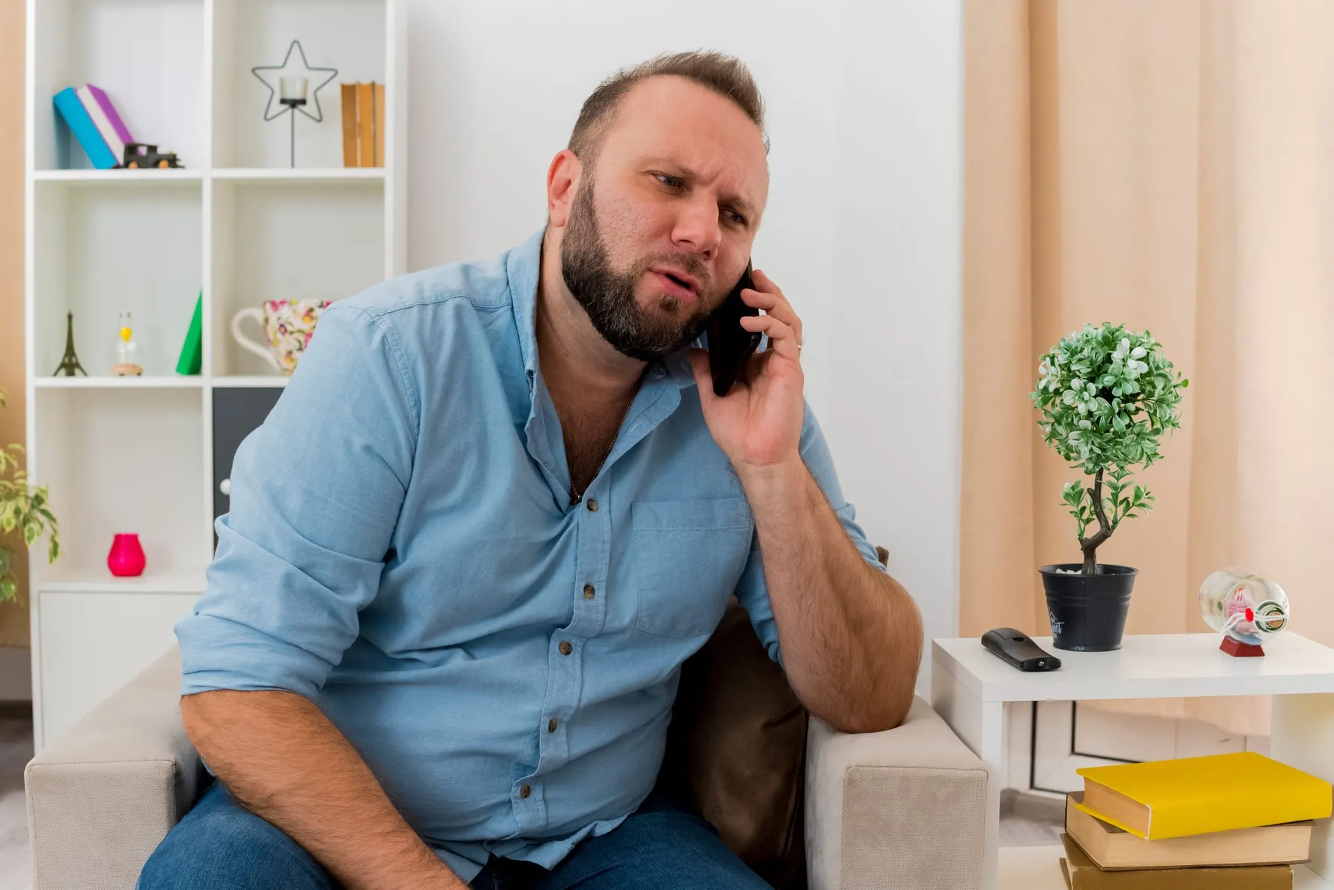 Man on the phone in his living room