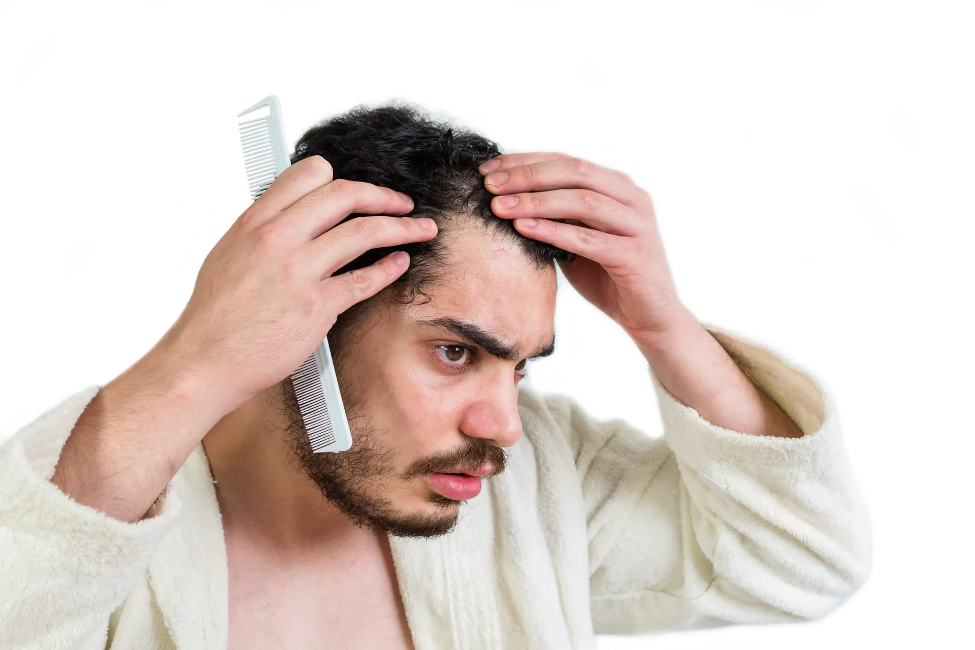 Man anxiously checking his hairline